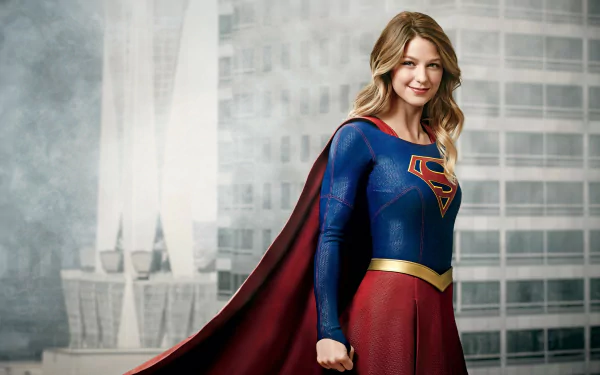 HD desktop wallpaper featuring Melissa Benoist as Supergirl from the TV show 'Supergirl,' with a cityscape background. She is wearing her iconic superhero costume and smiling confidently.