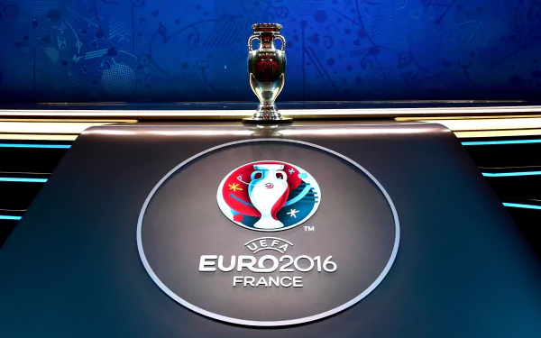 A vibrant HD wallpaper featuring the UEFA Euro 2016 logo and trophy on a sleek table, capturing the spirit of the tournament in a dynamic sports-themed backdrop.