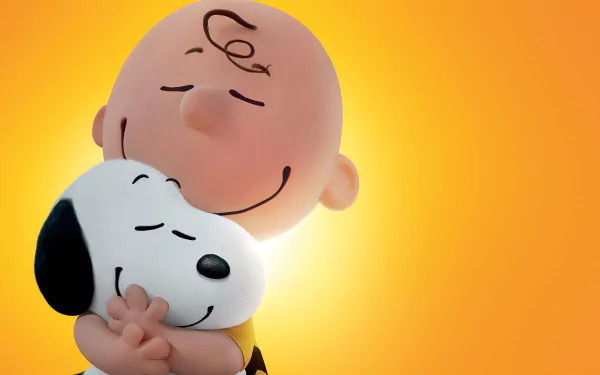 Charlie Brown hugs Snoopy against a warm orange backdrop, capturing a heartfelt moment from The Peanuts Movie in this vibrant HD desktop wallpaper.