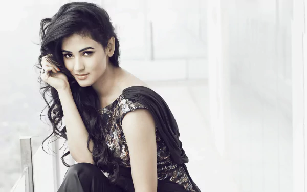 Sonal Chauhan, the renowned Bollywood actress, poses gracefully in this stylish 4K Ultra HD desktop wallpaper, showcasing her elegance and charm.