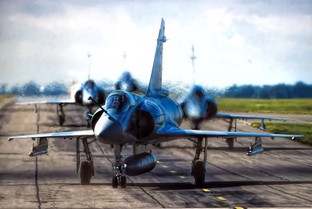 HD desktop wallpaper showing a Dassault Mirage 2000 military jet fighter warplane taxiing on a runway with a blurred background.