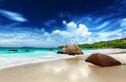 A stunning view of a Seychelles beach, featuring turquoise waters, soft sands, and lush greenery under a vibrant sky. This 4K Ultra HD wallpaper captures the beauty of nature.