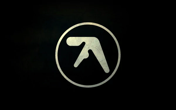 Dark textured HD PC desktop wallpaper featuring a pale circular Aphex Twin logo centered, minimalist electronic music emblem on a black background.