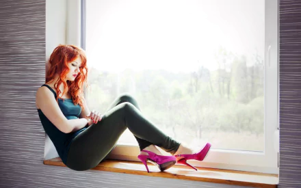 A redheaded woman, wearing lipstick, sits on a windowsill, resting her arms on her legs. Pink high heels are displayed in front of her. This HD wallpaper showcases a serene, natural backdrop.