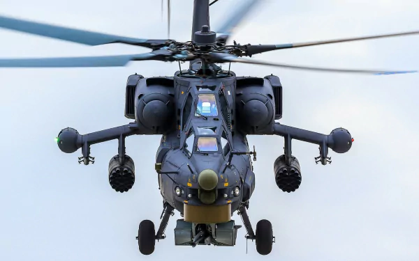Close-up HD image of a military Mil Mi-28 helicopter in flight, highlighting its detailed design against a clear sky background.