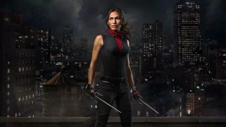 HD desktop wallpaper featuring Elodie Yung as Elektra Natchios from the Marvel Comics TV show Daredevil, poised against a dark city skyline at night.