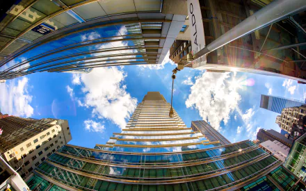 Fisheye lens view of towering skyscrapers against a blue sky, designed for an immersive HD city-themed desktop wallpaper.