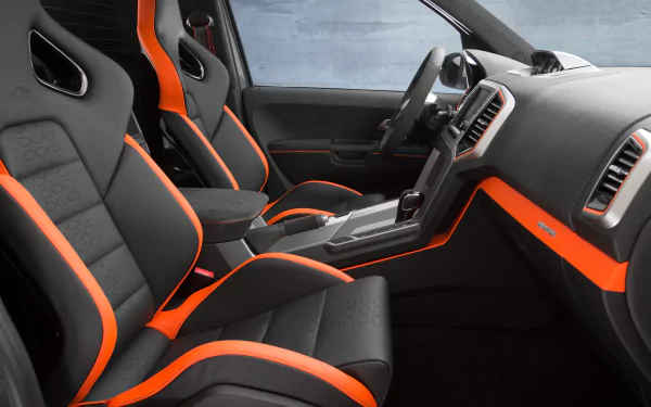 Interior view of a Volkswagen Amarok with black seats and orange trim, shown as an HD PC desktop wallpaper and background.