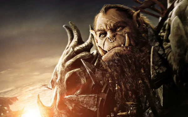 HD PC desktop wallpaper featuring a detailed close-up of an orc character from the Warcraft movie, showcasing intense expression and fantasy armor.
