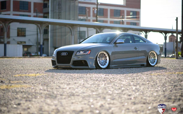 HD PC desktop wallpaper: low-slung JDM-styled gray Audi S5 in an industrial lot, a modified Audi vehicle with deep-dish wheels and an aggressive stance.