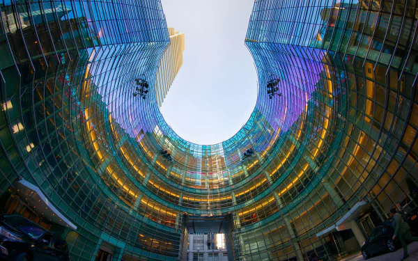 Fisheye lens view of towering city buildings encircling the sky, forming an HD wallpaper.