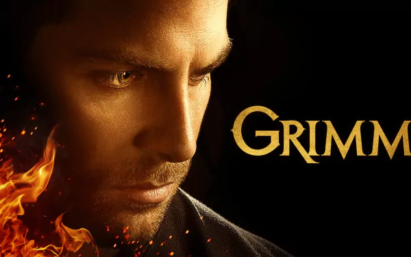 HD PC desktop wallpaper featuring a close-up of a man's intense face with glowing eyes and flames, showcasing the TV show Grimm title on a dark background.