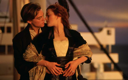 HD wallpaper featuring Leonardo DiCaprio and Kate Winslet in a romantic scene from the film Titanic.