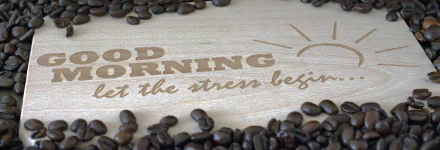 HD PC desktop wallpaper: coffee beans scattered around a wooden sign reading GOOD MORNING — let the stress begin, a playful coffee/food statement for a background.