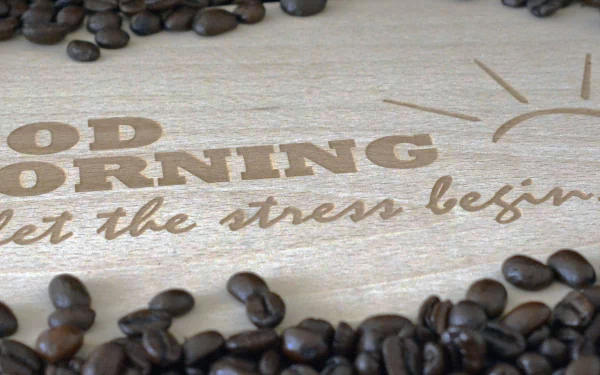 HD PC desktop wallpaper: coffee beans scattered around a wooden sign reading GOOD MORNING — let the stress begin, a playful coffee/food statement for a background.