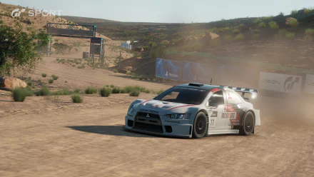 HD PC desktop wallpaper/background from the video game Gran Turismo Sport: white rally car kicks up dust while drifting on a sunlit dirt track.