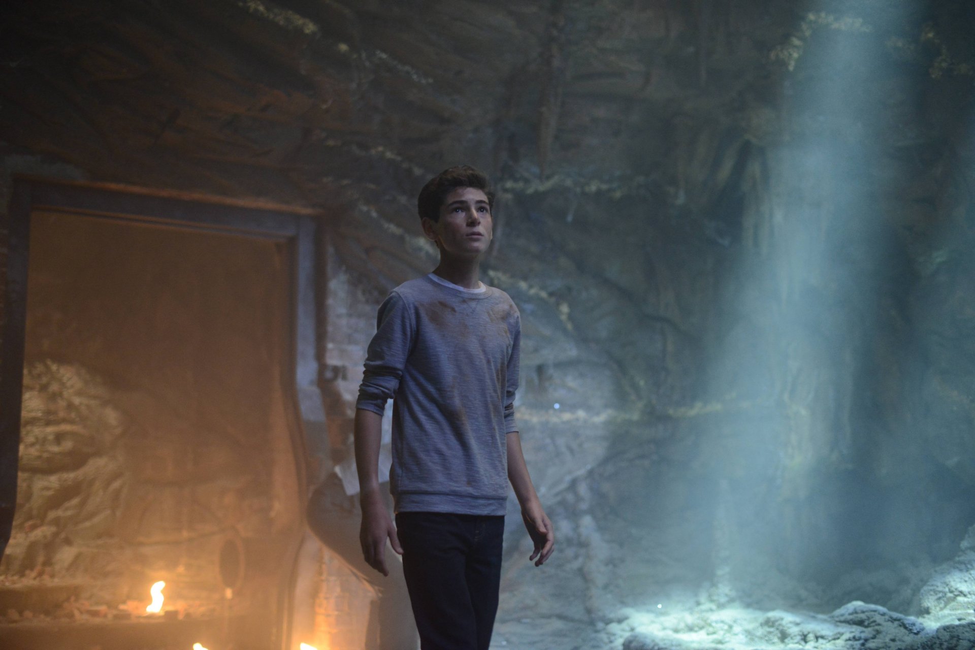 HD PC desktop wallpaper featuring David Mazouz as Bruce Wayne in the Gotham TV show, standing in a dimly lit cave setting.