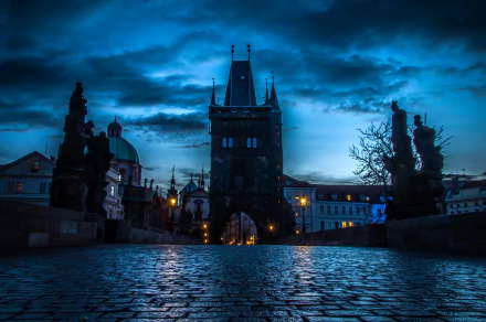 Night view of Prague's historic cityscape in the Czech Republic, featuring illuminated man-made structures and a dramatic blue sky, captured in HD for desktop wallpaper.