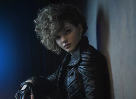 HD desktop wallpaper featuring Selina Kyle from the TV show Gotham, showcasing her intense expression and iconic leather jacket in a moody, dark setting.