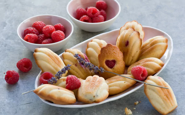 Still-life HD PC desktop wallpaper and background: madeleines on a plate with fresh raspberries, bowls of berries and lavender sprigs — a fruit and pastry food scene.