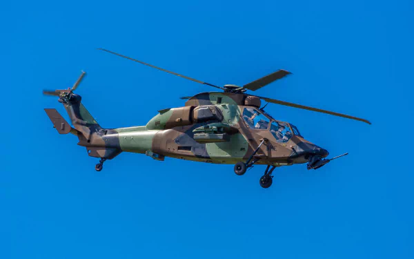 Eurocopter Tiger attack helicopter in military camouflage flying against a clear blue sky — 4K Ultra HD PC desktop wallpaper background