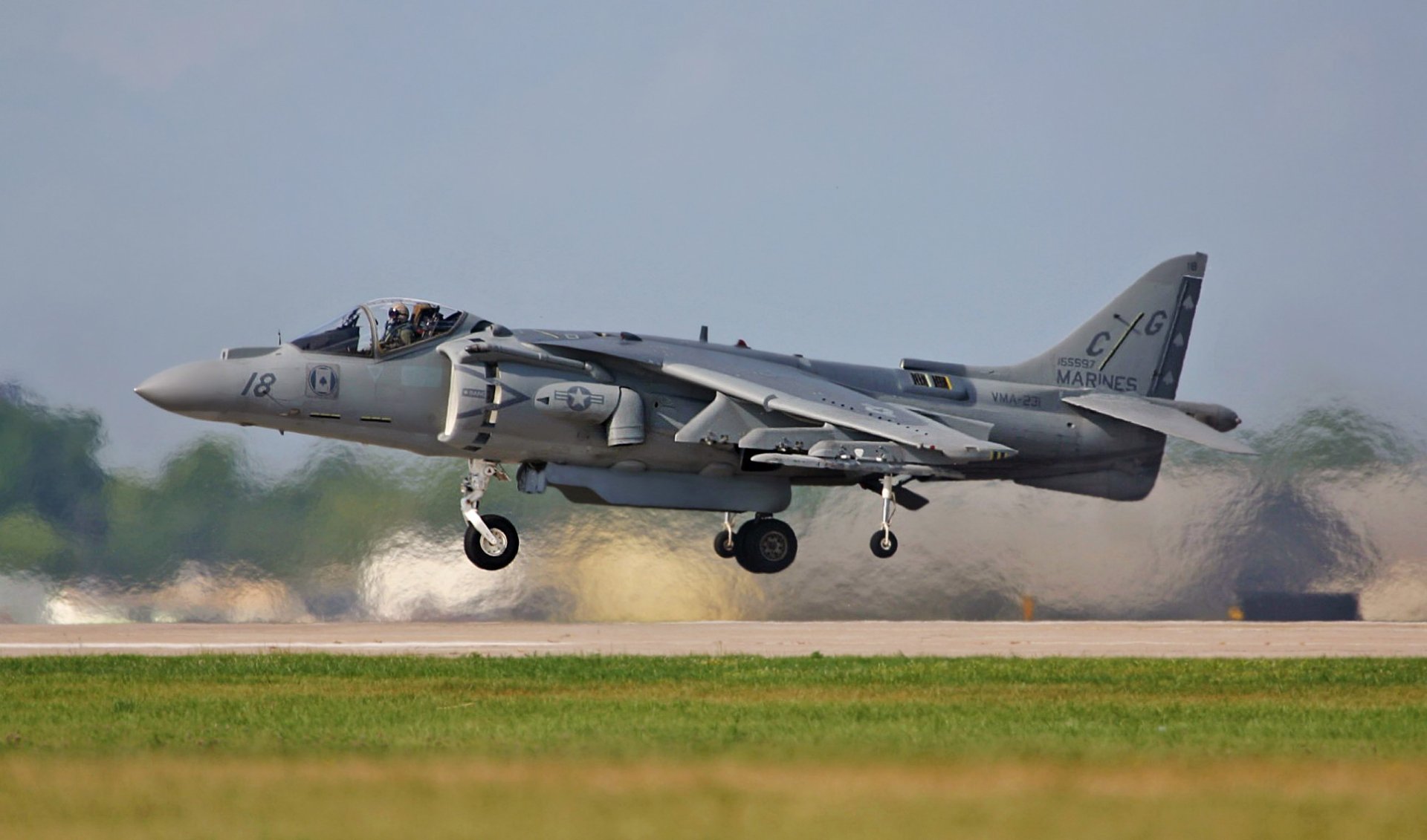 McDonnell Douglas AV-8B Harrier II military jet captured mid-landing, featured as an HD PC desktop wallpaper and background.