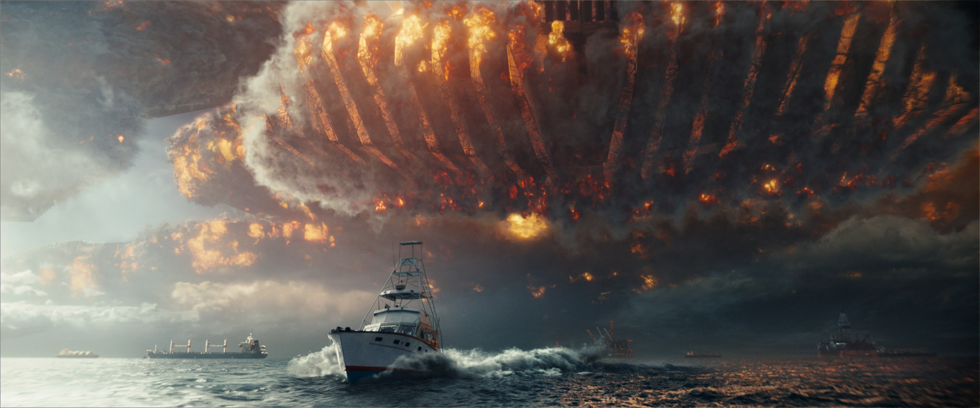 HD PC desktop wallpaper featuring a dramatic scene from the movie Independence Day: Resurgence with a fishing boat facing an enormous fiery alien spaceship overhead.