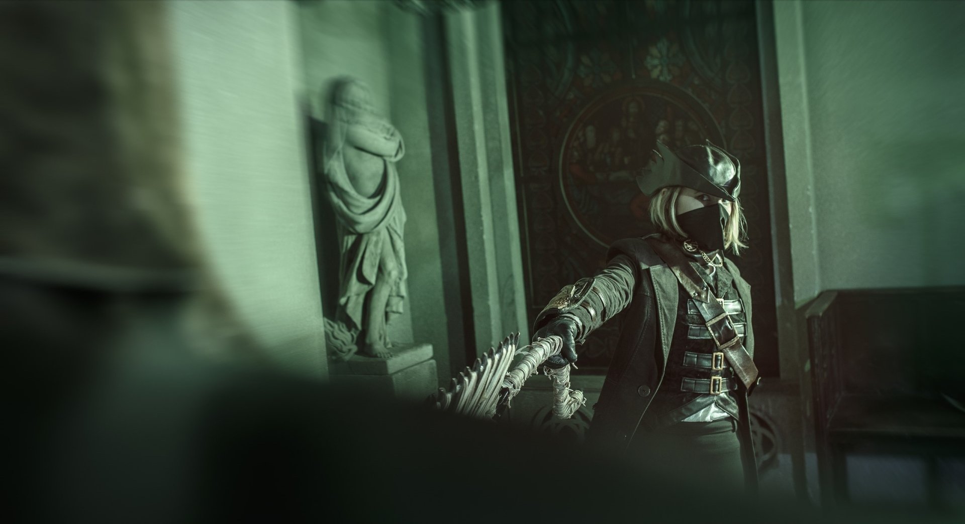 HD PC desktop wallpaper featuring a woman cosplaying as a character from Bloodborne in a dimly lit, gothic setting.
