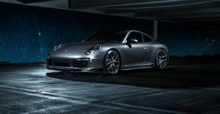 Silver Porsche 911 Carrera 4S parked in a dimly lit space with a starry night sky background, HD desktop wallpaper showcasing the sleek vehicle design.