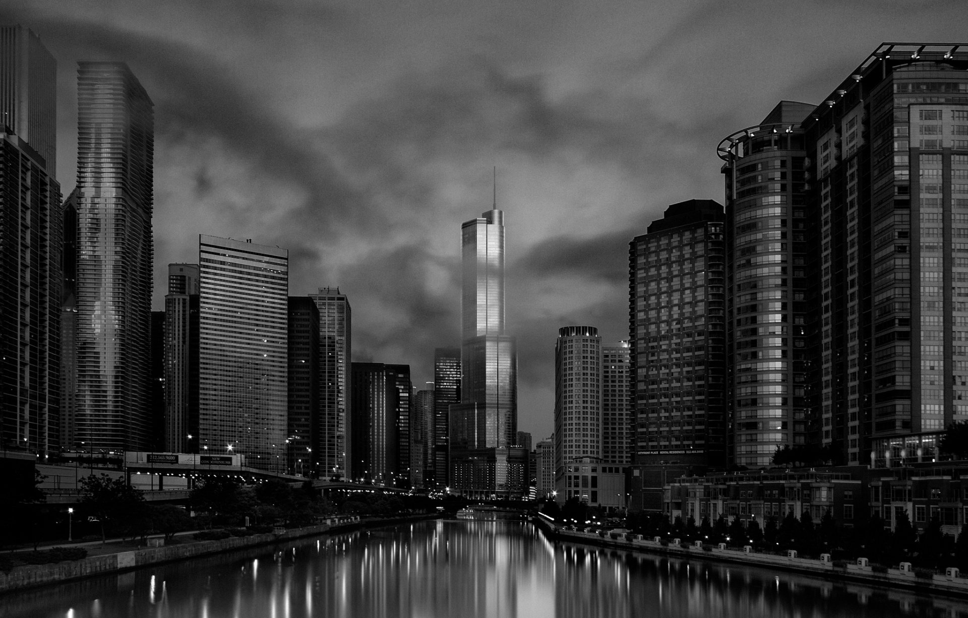 Black and white HD desktop wallpaper of Chicago’s skyscrapers reflecting on the river, showcasing the city’s iconic man-made architecture and urban skyline.