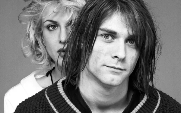 Black-and-white HD PC desktop wallpaper: music-themed portrait of a 1990s grunge musician in the foreground with a woman behind him, moody close-up.