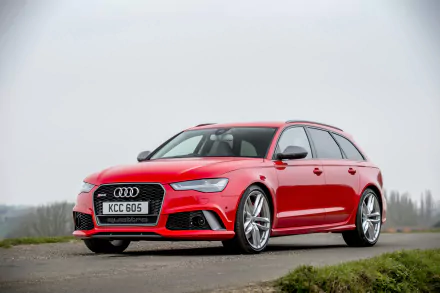 Red Audi RS6 wagon car parked on a misty roadside — a high-performance Audi vehicle shown as a 2K Quad HD PC desktop wallpaper/background.