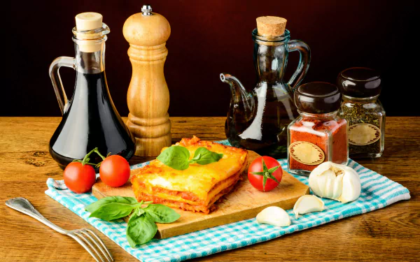 5K Ultra HD PC desktop wallpaper still life of lasagna on a wooden board with oil bottles, pepper mill, tomatoes, garlic and basil — meal food background.
