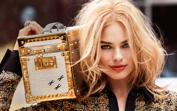 A glamorous blonde actress smiles confidently while holding a stylish bag, showcasing her chic look with striking lipstick, embodying modern Australian celebrity elegance.