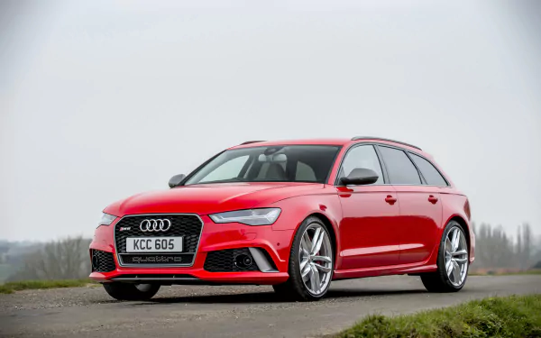Red Audi RS6 wagon car parked on a misty roadside — a high-performance Audi vehicle shown as a 2K Quad HD PC desktop wallpaper/background.