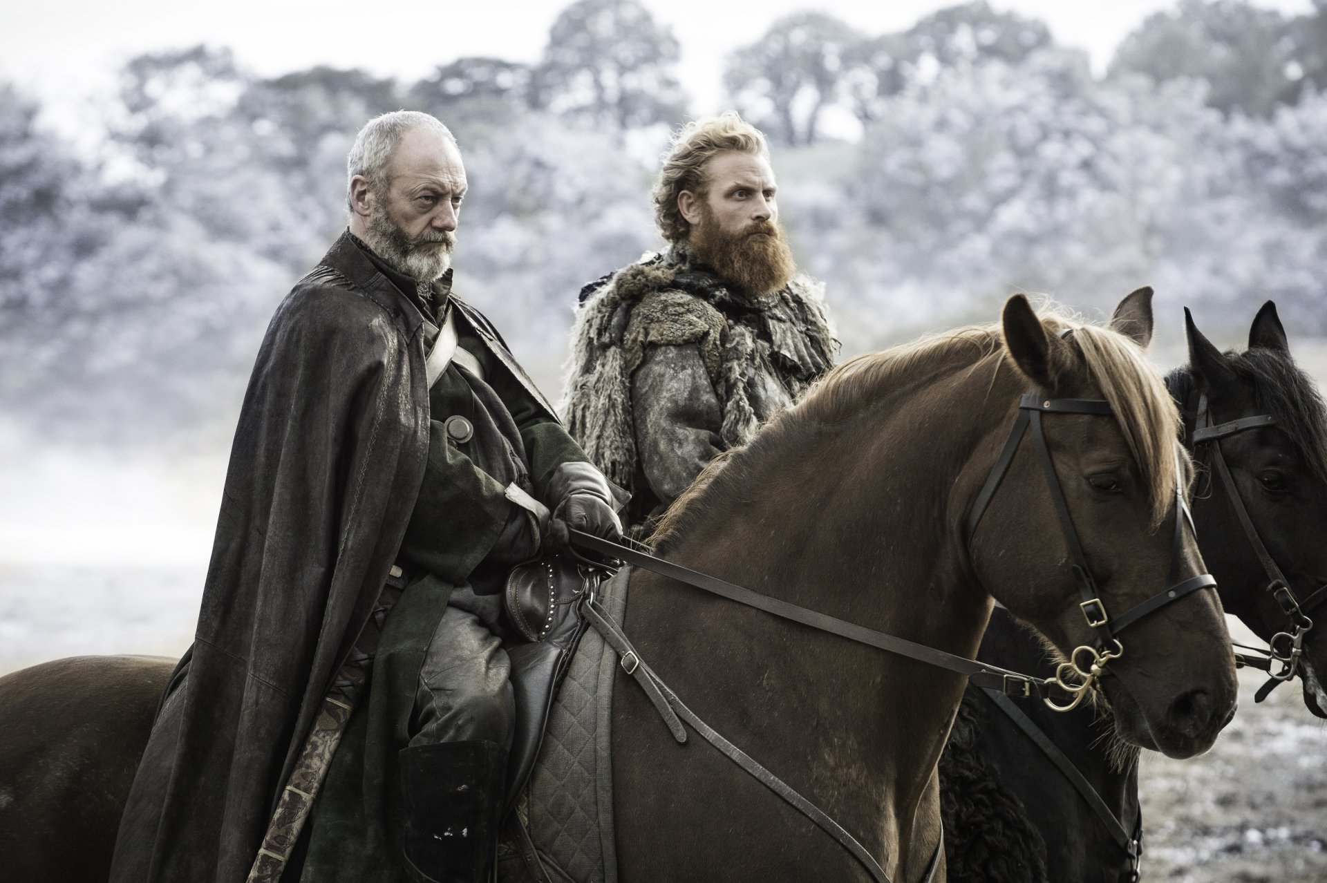 Tormund Giantsbane and Davos Seaworth, played by Kristofer Hivju and Liam Cunningham in Game of Thrones, ride horses through a snowy landscape in this 4K Ultra HD desktop wallpaper.