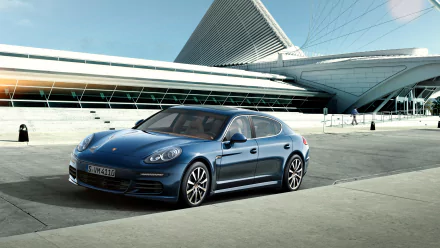 HD desktop wallpaper featuring a blue Porsche Panamera 4S parked in front of a modern architectural structure, showcasing the sleek design of the Porsche vehicle.