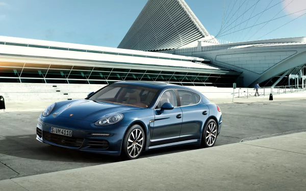 HD desktop wallpaper featuring a blue Porsche Panamera 4S parked in front of a modern architectural structure, showcasing the sleek design of the Porsche vehicle.