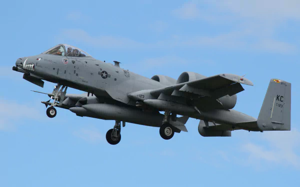 A Fairchild Republic A-10 Thunderbolt II jet fighter in flight against a clear blue sky, showcased as a 4K Ultra HD wallpaper and background.