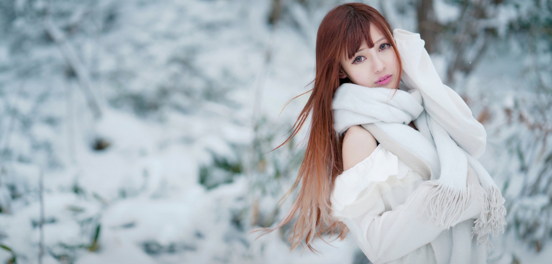 HD desktop wallpaper featuring an Asian woman with brown eyes and brunette hair, wearing a white scarf in a snowy landscape.