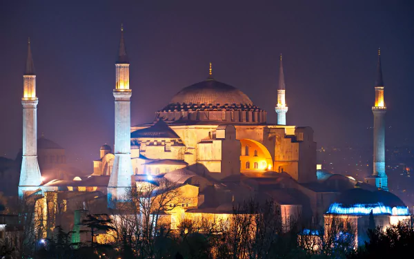 A stunning HD desktop wallpaper featuring the illuminated Hagia Sophia at night, showcasing its majestic architecture and religious significance against a dark sky.
