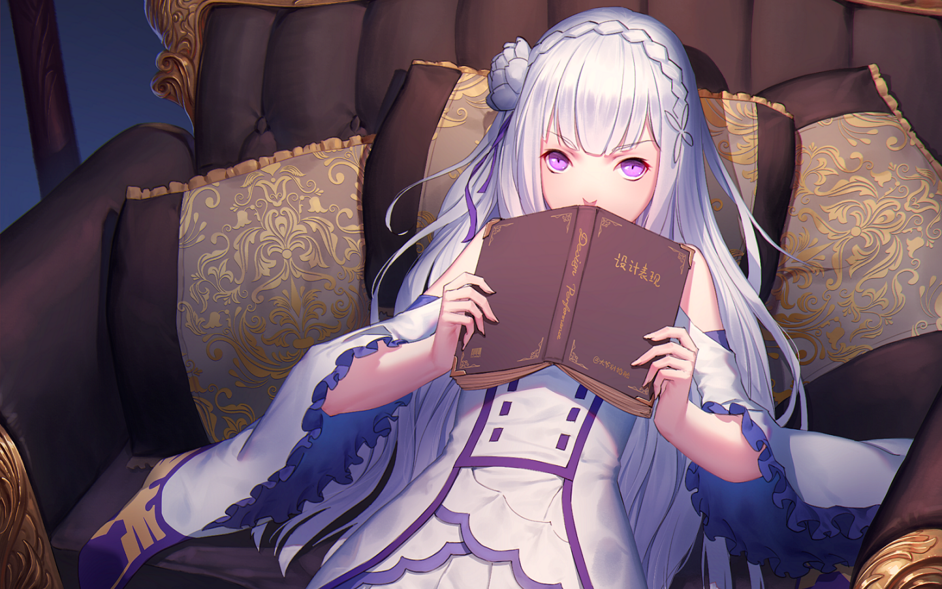 Emilia from Re:ZERO - Starting Life in Another World sits elegantly on a luxurious chair, holding a book, with a serene expression in an enchanting HD desktop wallpaper.