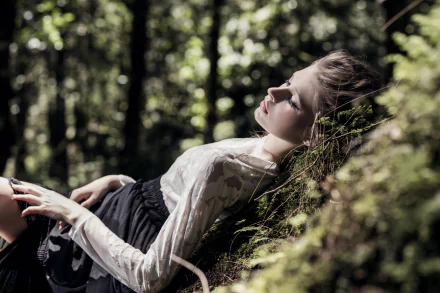 A serene woman model lies down against a mossy surface in a softly lit forest with bokeh, captured in stunning 8K Ultra HD detail for a PC desktop wallpaper.