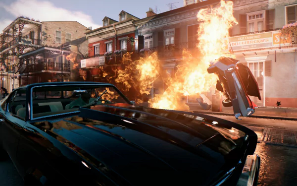 4K Ultra HD Mafia III PC wallpaper showing a vintage car in the foreground with a fiery explosion and a flipping vehicle on a city street in the background.