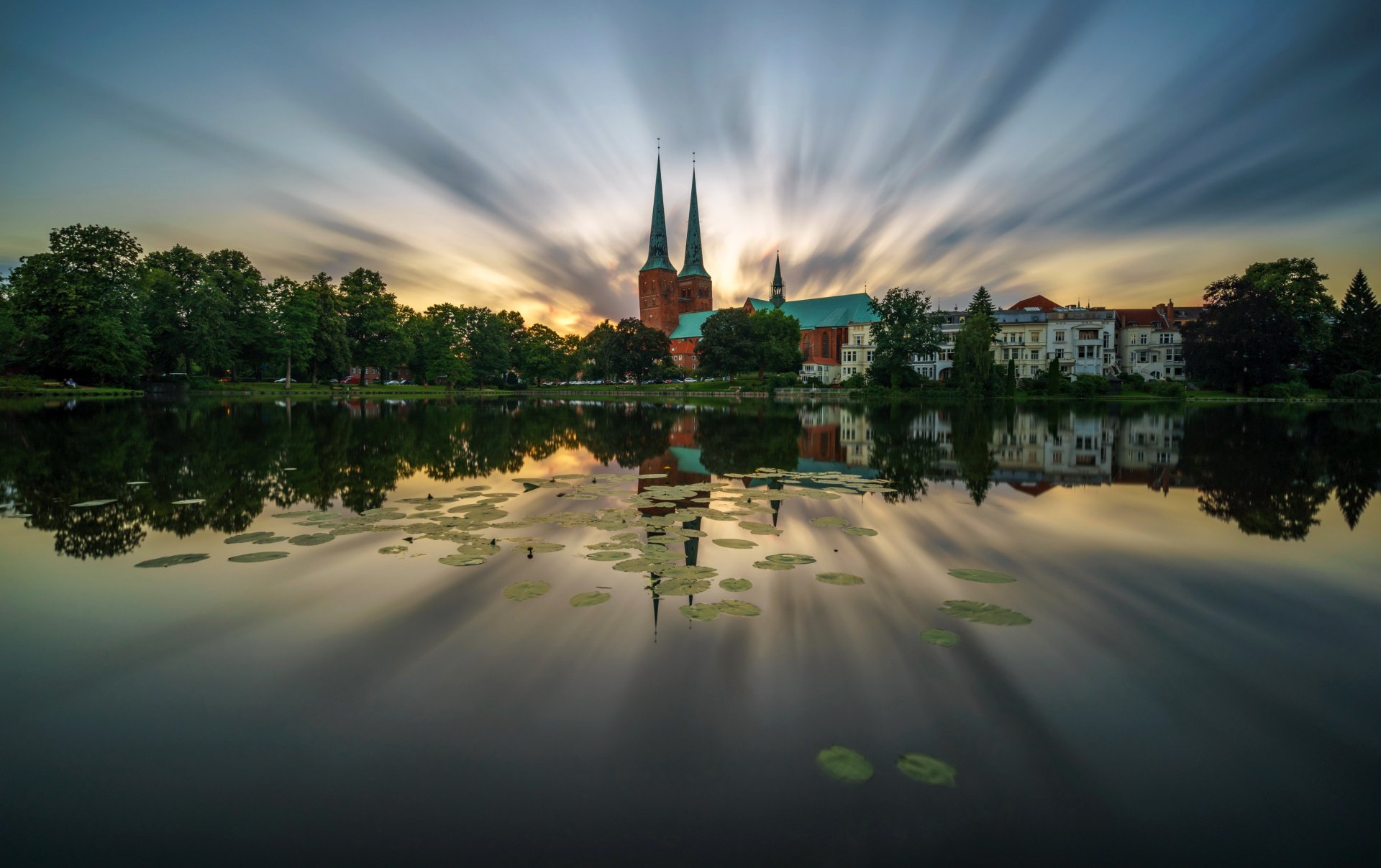 Download Reflection Sunset Sky Tree Pond Lubeck Cathedral Lübeck Germany Religious Cathedral HD Wallpaper