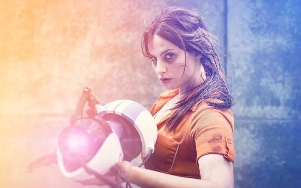 HD PC desktop wallpaper featuring a woman cosplaying as Chell from Portal 2, holding a portal gun against a textured, atmospheric background.