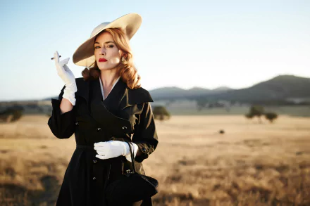 HD desktop wallpaper featuring blonde English actress Kate Winslet in a fashion hat and lipstick, portraying her role in the movie The Dressmaker.