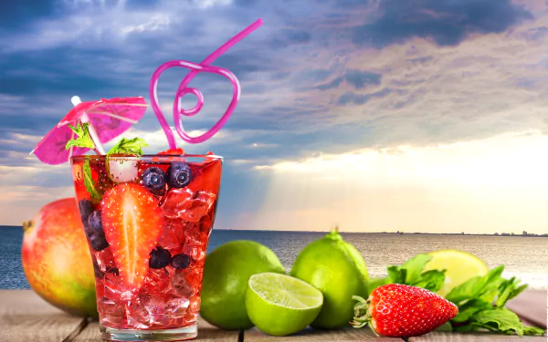 A vibrant summer cocktail with strawberries, lime, and blueberries in a glass with a pink straw and umbrella, set against a dramatic cloudy sky and waterfront background in 4K Ultra HD.