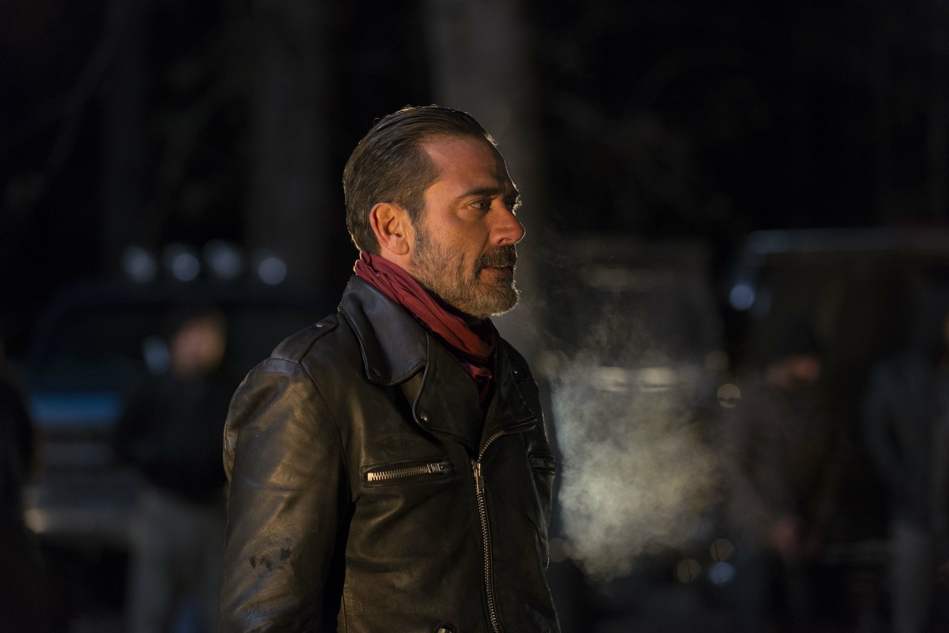 A striking HD wallpaper featuring Jeffrey Dean Morgan as Negan from The Walking Dead, showcasing his intense expression and iconic leather jacket in a dramatic setting.