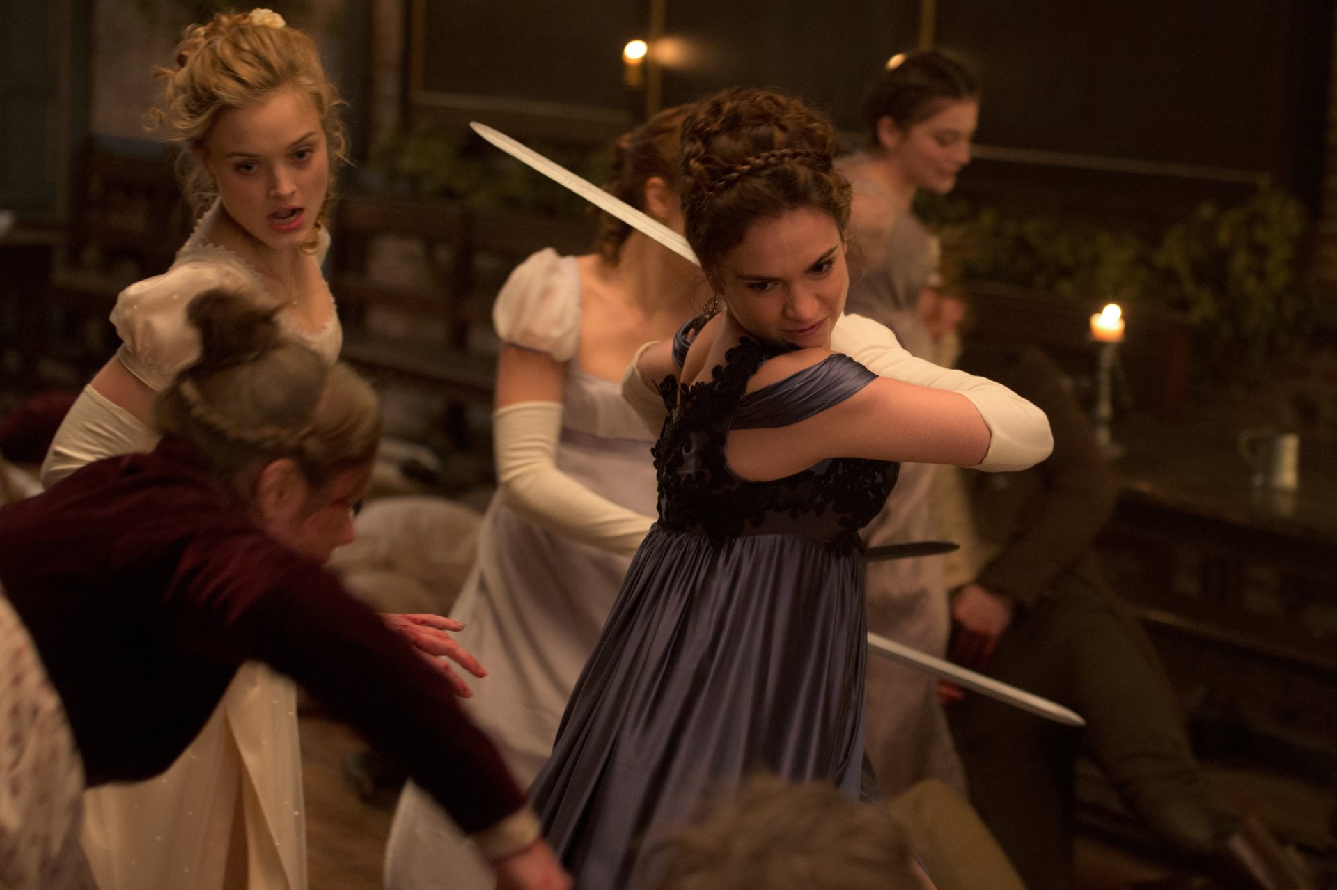 4K Ultra HD PC desktop wallpaper: a scene from the movie Pride and Prejudice and Zombies — Regency-era women in gowns battling zombies with swords in a candlelit room.